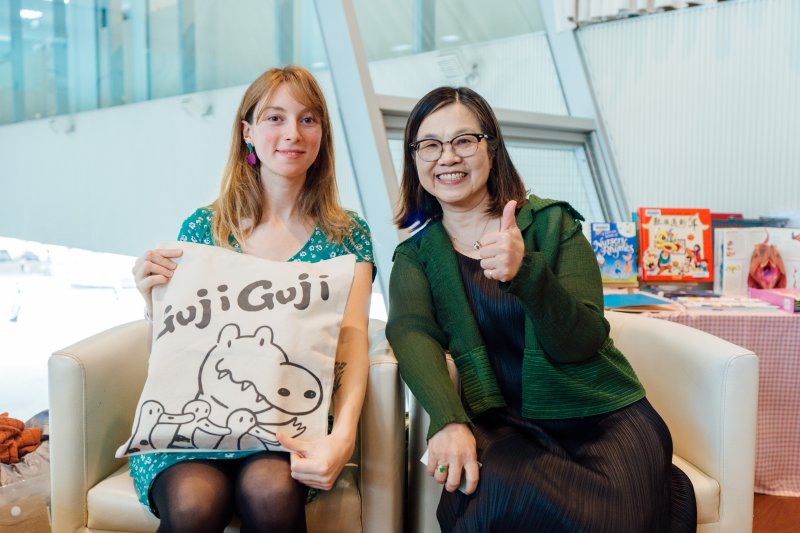 圖／高雄市立圖書館館長李金鴦（左）特別贈送高市圖形象禮品予諾依慕‧菲法赫。