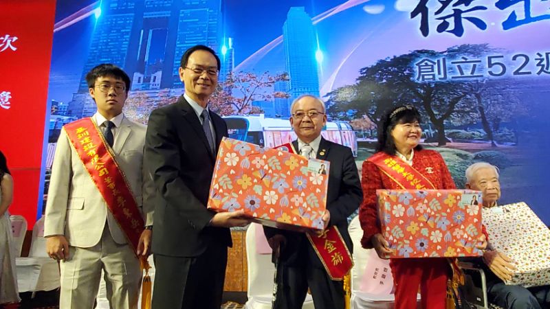 議會秘書長黃錦平(左)代表議長康裕成贈送當選人禮物。（漾新聞記者陳雯萍攝)